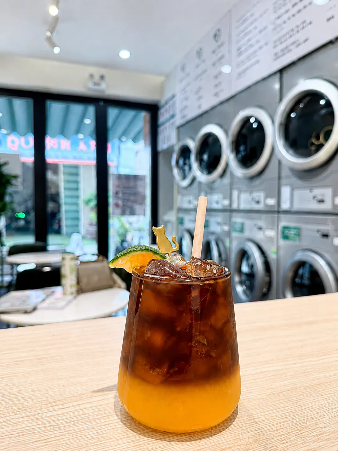 Iced fruit tea at Flower Cafe with laundry machines in the background