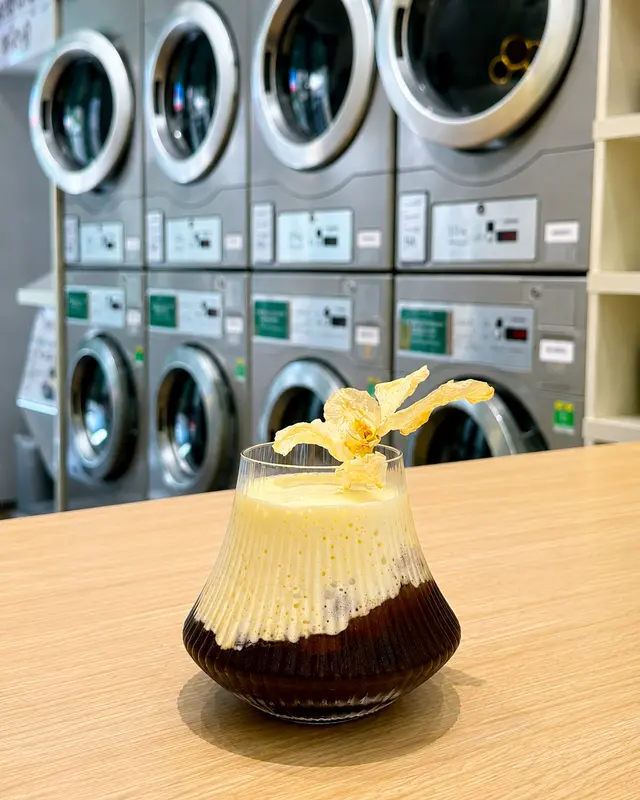 Salted coffee at Flower Laundromat & Cafe with laundry machines in the background